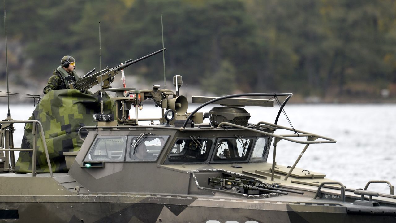 A member of the Swedish military mans a gun on a fast-attack craft on Saturday, October 18.
