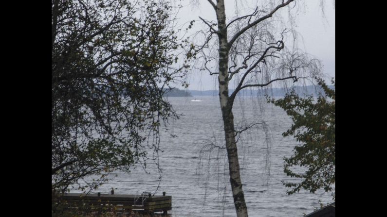 In this handout from the Swedish Defense Ministry, a dark object in a white wake is seen in the Baltic Sea. Some suspect it is the mysterious vessel the Swedish Navy is looking for.