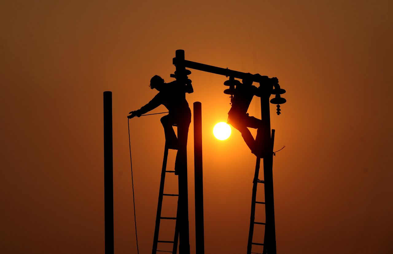 Workmen maintain energy infrastructure in India ahead of a holy festival near the Ganges. "The first major problem of energy in emerging markets is getting access to it in the first place, the second problem is that when there is access it gets stolen," says Alain Ballock.