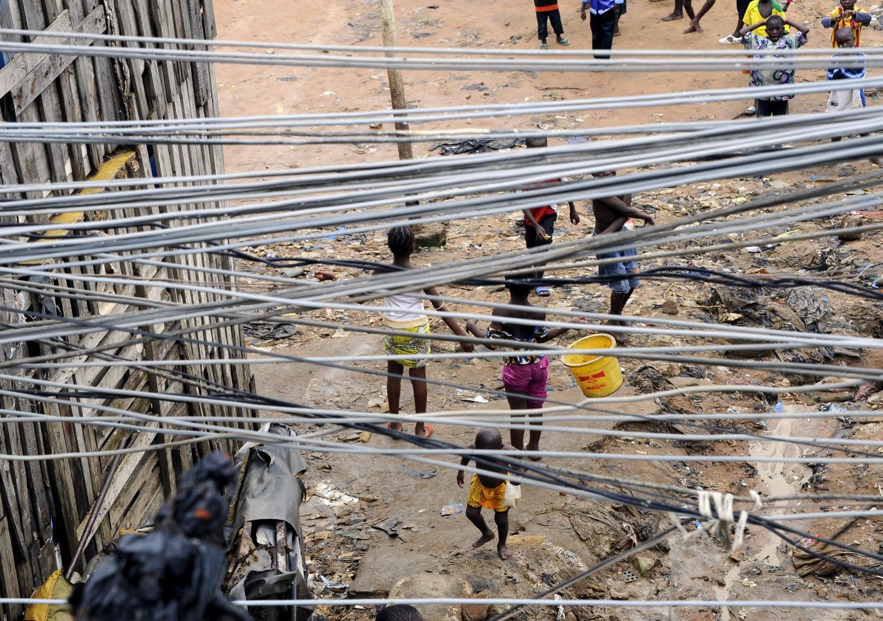 Power lines fan out across a street in Sierra Leone. The often chaotic nature of energy infrastructure in Africa and India makes energy theft easy.