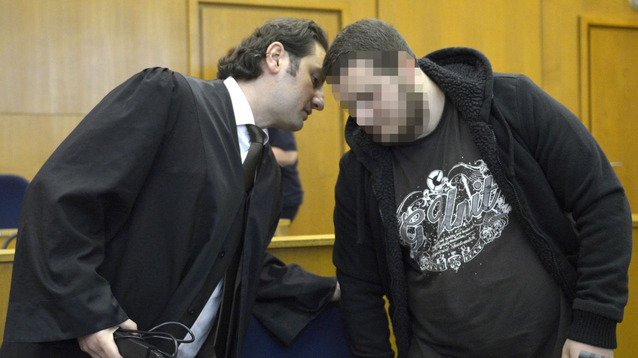 German alleged jihadist Kreshnik B (R) listens to his lawyer Mutlu Guenal (L) as he arrives at the higher regional court in Frankfurt. His face is pixelated for legal reasons.