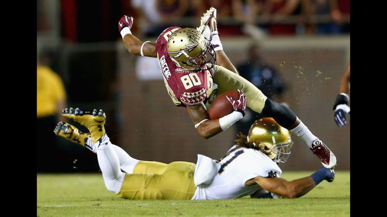 Florida State wide receiver Rashad Greene is tackled by Notre Dame's Matthias Farley during a college football game played Saturday, October 18, in Tallahassee, Florida. Greene's Seminoles held off the Fighting Irish 31-27 to win a battle of two undefeated teams.