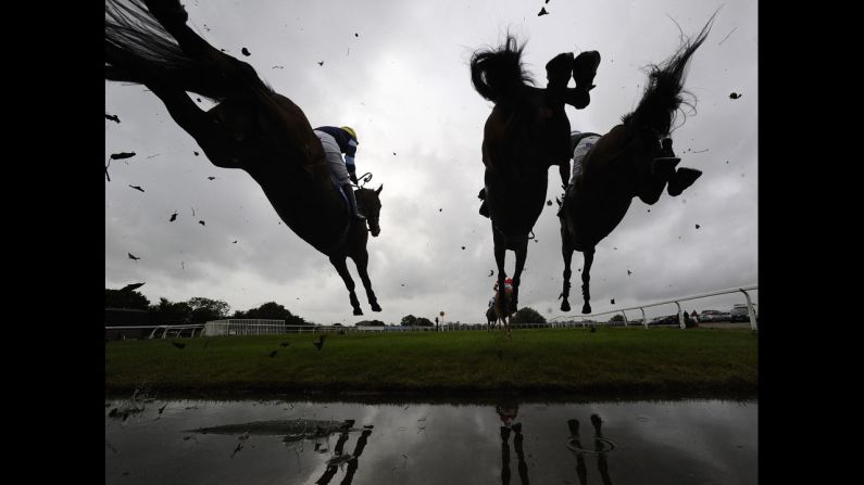 Nick Scholfield, at left aboard I'm In Charge, clears a jump on the way to winning a steeplechase race Thursday, October 16, at Wincanton Racecourse in Wincanton, England.