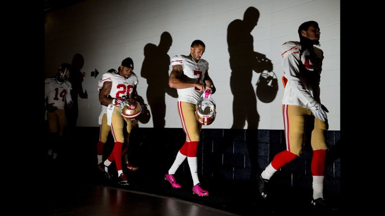 The San Francisco 49ers, including star quarterback Colin Kaepernick, second from right, walk through a stadium tunnel in Denver before playing the Broncos on Sunday, October 19.