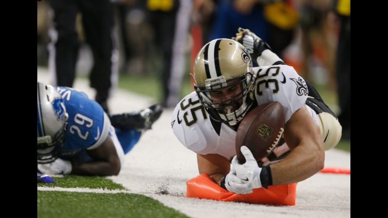 Austin Johnson of the New Orleans Saints smashes into a pylon as he scores a touchdown Sunday, October 19, in Detroit. The Lions came back to win the game 24-23.