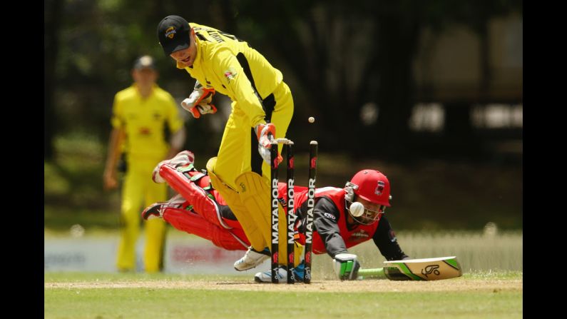 Sam Whiteman of the Western Australia Warriors tries to run out a diving Alex Ross on Friday, October 17, during a One Day Cup match between Western Australia and South Australia in Sydney. Western Australia won by four wickets.