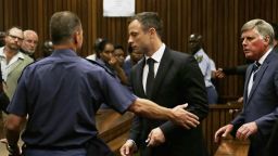 Oscar Pistorius, center, is led out of court in Pretoria, South Africa, Tuesday, Oct. 21, 2014.  Pistorius received a five-year prison sentence for culpable homicide by judge Thokozile Masipais for the killing of his girlfriend Reeva Steenkamp last year (AP Photo/Themba Hadebe)