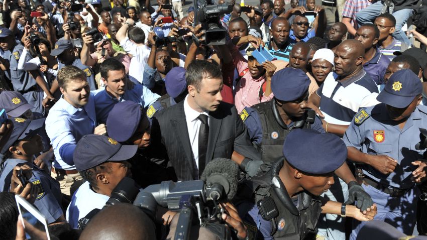 Oscar Pistorius, center, arrives outside the court in Pretoria, South Africa, Tuesday, Oct. 21, 2014. Pistorius will finally learn his fate  when judge Thokozile Masipais is expected to announce the Olympic runner's sentence for killing girlfriend Reeva Steenkamp  (AP Photo/Antoine de Ras/Independent Newspapers)  SOUTH AFRICA OUT