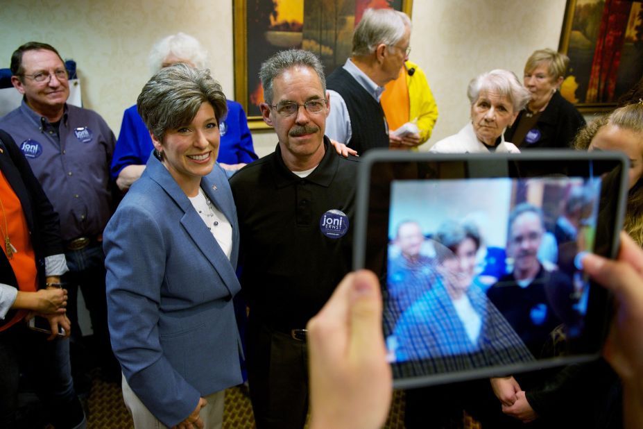 Ernst poses with supporters during a campaign rally in Cedar Rapids last month.