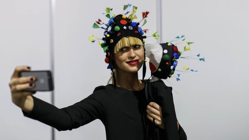 A model in Kiev, Ukraine, takes a selfie as she waits backstage during Ukrainian Fashion Week on Friday, October 17.