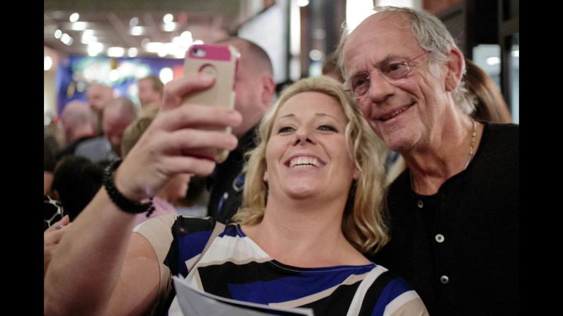 A woman takes a selfie with actor Christopher Lloyd during a red-carpet event for the movie "Pirate's Code: The Adventures of Mickey Matson," which was held Thursday, October 16, in Grand Rapids, Michigan. 
