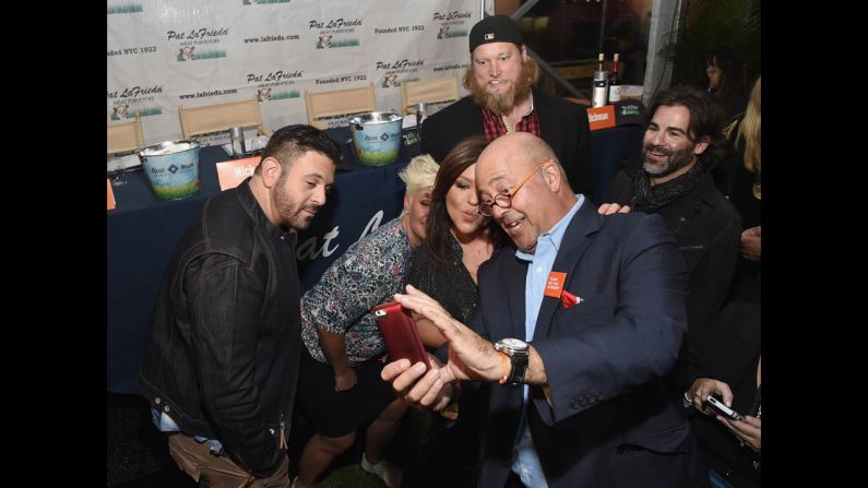 Television personalities Rachael Ray and Andrew Zimmern take a selfie Friday, October 17, at the Blue Moon Burger Bash in New York.