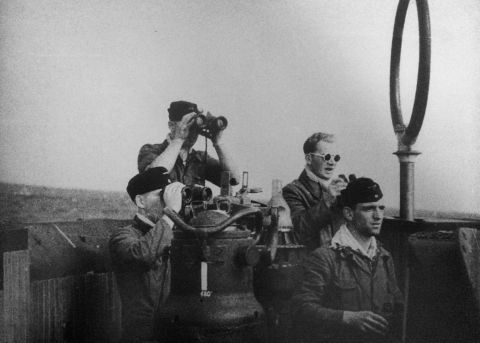 Crew members are seen in the sub's conning tower.