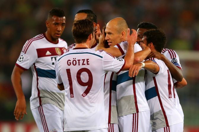 Bayern Munich's Dutch playmaker Arjen Robben is mobbed by his teammates after scoring the opening goal against AS Roma in the Italian capital. The German champions would go on to score six more.