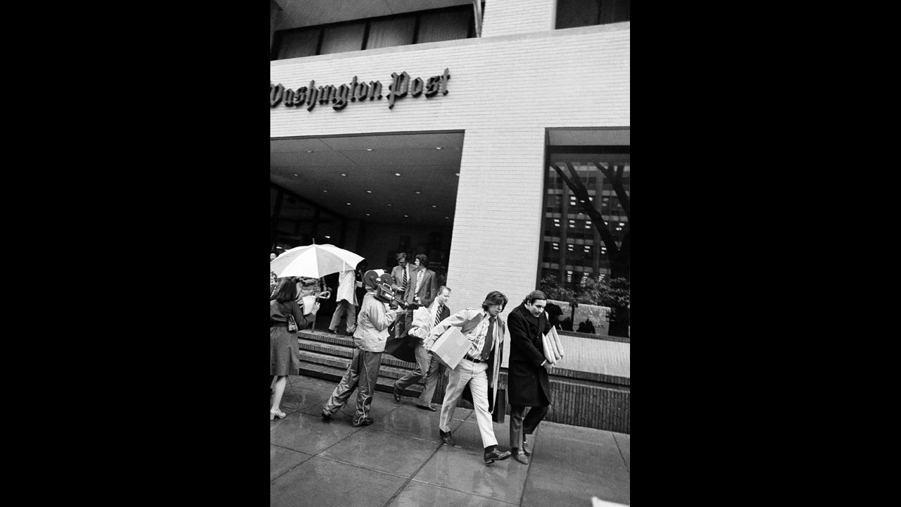 Bernstein, left, and Woodward, along with other editorial employees, walk off the job at the Post in Washington, April 8, 1974, after the local arm of the American Newspaper Guild went on strike against the paper.