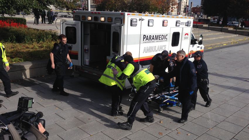 Police and paramedics transport a wounded Canadian soldier on Wednesday, October 22, in Ottawa, Canada.