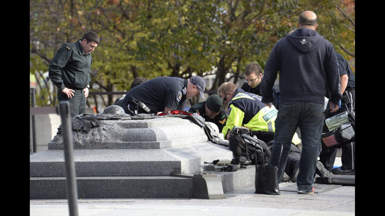 Emergency personnel tend to a person who was shot at the National War Memorial. Cpl. Nathan Cirillo, a Canadian army reservist, was shot and killed as he and another soldier stood guard at the memorial, police said.
