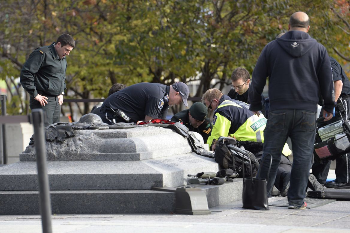 Emergency personnel tend to a person who was shot at the National War Memorial. A Canadian soldier was shot and killed as he and another soldier stood guard at the memorial, police said.