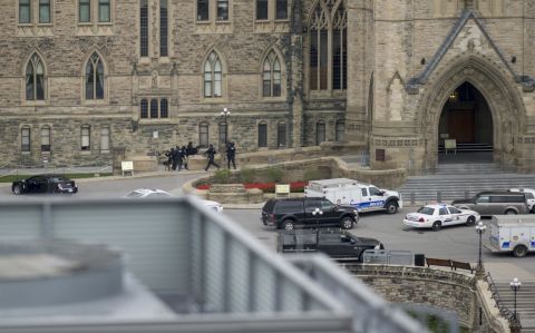 Police enter Canada's Parliament building on Wednesday, October 22, in Ottawa. A Canadian soldier was fatally shot at the National War Memorial nearby, and there were gunshots at the Parliament building itself, Ottawa police spokesman Marc Soucy said. One male suspect was also killed, police said.