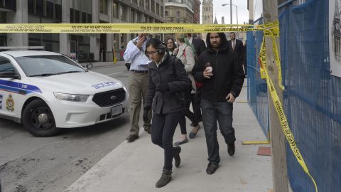 Civilians leave a secured area around Parliament Hill.