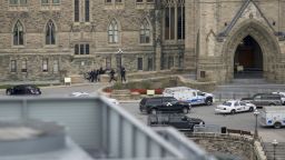 Police teams enter Centre Block at Parliament Hill in Ottawa on Wednesday Oct. 22, 2014.  A soldier standing guard at the National War Memorial was shot by an unknown gunman and people reported hearing gunfire inside the halls of Parliament. Prime Minister Stephen Harper was rushed away from Parliament Hill to an undisclosed location, according to officials. (AP Photo/The Canadian Press, Justin Tang)
