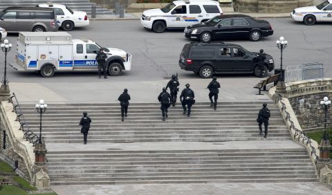 Police move toward the Parliament building.