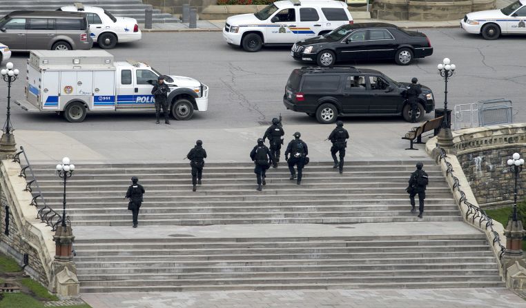 Police move toward the Parliament building.