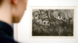 A file photo dated 23 January 2014 of a person looking at the picture 'Storm Troopers Advancing Under Gas' by Otto Dix in the Kunstmuseum in Stuttgart,†Germany.