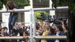 The sister of murdered Filipino transgender woman Jennifer Laude, climbs the gate of the facility where Private First Class Joseph Scott Pemberton is detained at the Armed Forces of the Philippine (AFP) headquarters in Manila on October 22, 2014.