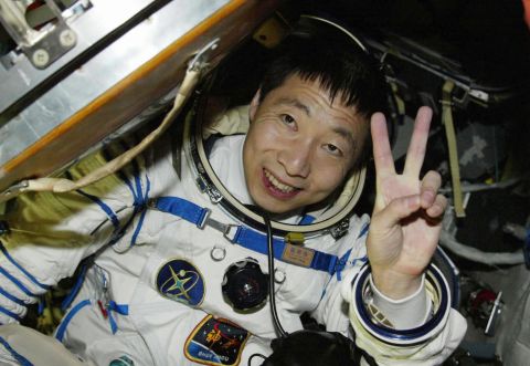Chinese astronaut Yang Liwei waves from the Shenzhou V capsule after completing China's first manned space flight in 2003.