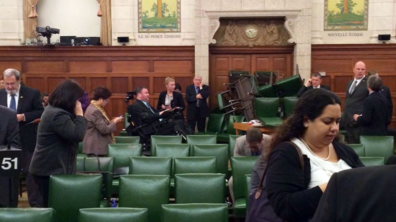 In this photo provided by Canadian politician Nina Grewal, members of Canada's Parliament barricade themselves in a meeting room Wednesday, October 22, after <a href="http://www.cnn.com/2014/10/22/world/gallery/canada-shooting-parliament/index.html">shots were fired on Parliament Hill</a> in Ottawa. A Canadian soldier was fatally shot at the National War Memorial nearby, police said, and the alleged gunman was killed.