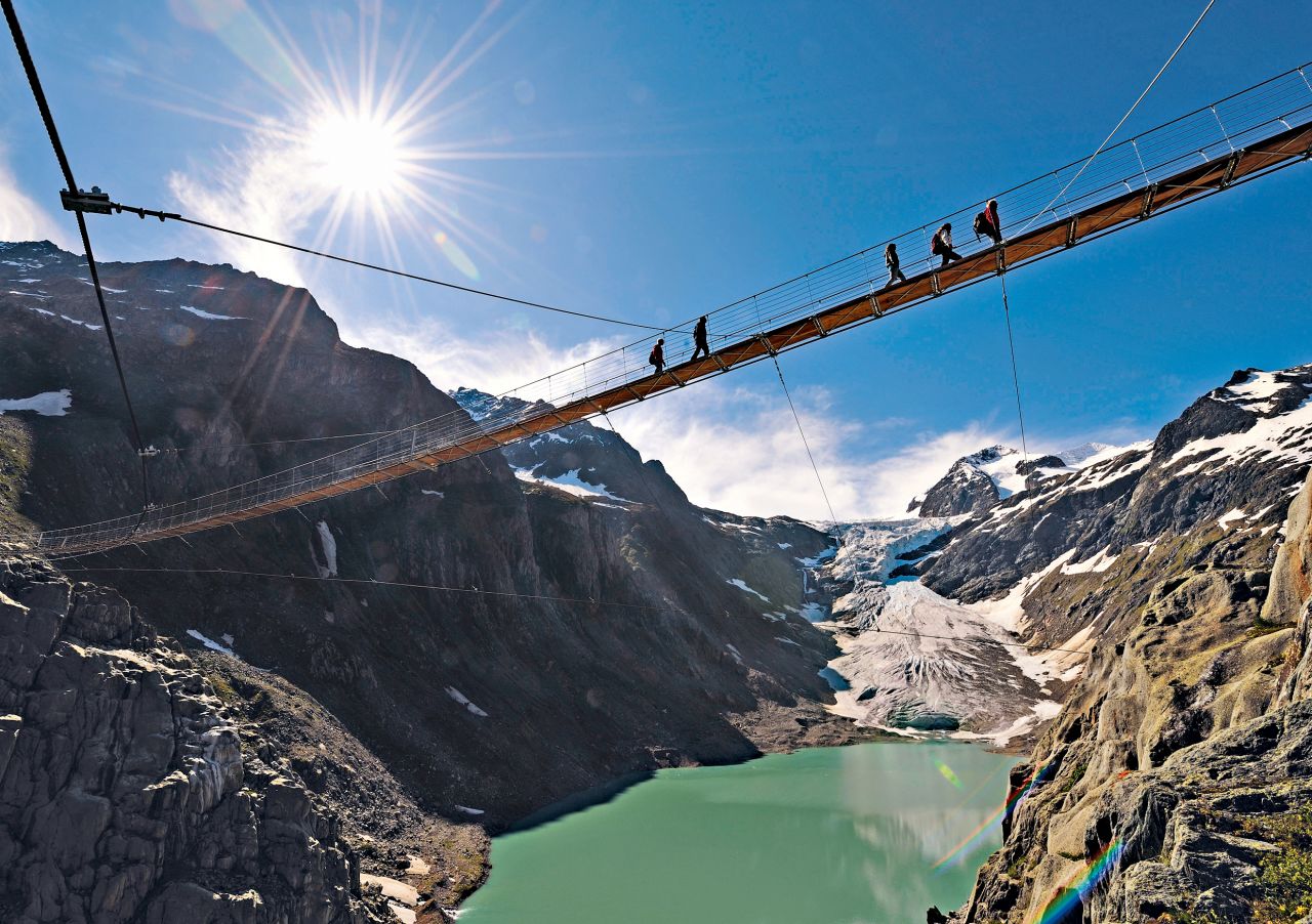 <strong>Trift Bridge (Gadmen, Switzerland):</strong> The mountaineering hut at the top of Tift Glacier was once reachable by foot. When the glacier started to shrink, the 170-meter-long Tift Bridge in Gadmen, Switzerland, became the only way to access the hut.