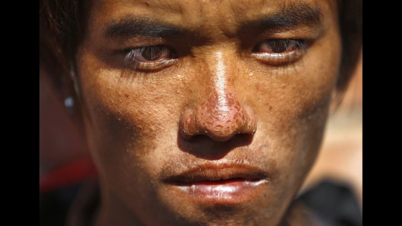 Avalanche survivor Sete Tamang waits outside a morgue for the bodies of some of his colleagues Monday, October 20, in Kathmandu, Nepal. Officials confirmed that <a href="http://www.cnn.com/2014/10/18/world/asia/nepal-snowstorm/index.html">at least 39 people had died</a> in an exceptionally heavy snowfall.