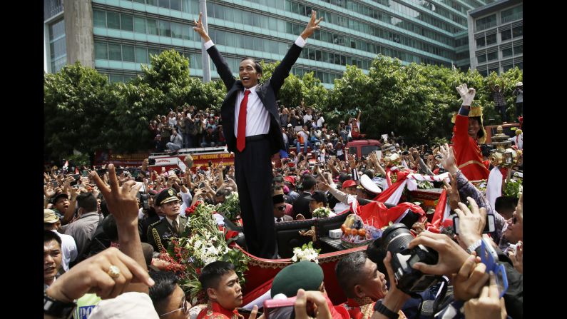 Indonesia's new President, Joko Widodo, acknowledges the crowd after his inauguration in Jakarta, Indonesia, on Monday, October 20.