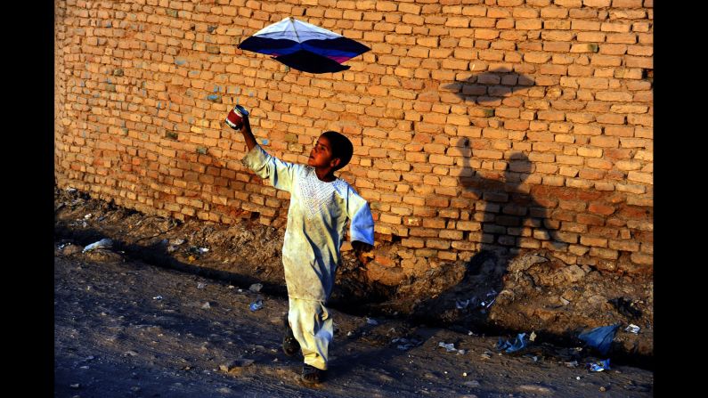A child plays with a kite on the outskirts of Herat, Afghanistan, on Monday, October 20.