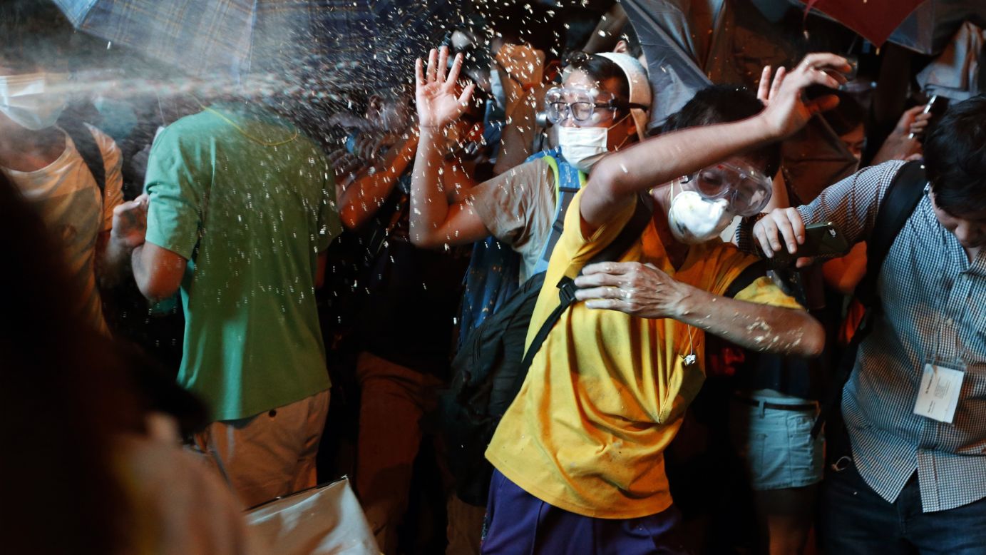Riot police use pepper spray on pro-democracy protesters during a confrontation Friday, October 17, at the Mong Kok shopping district in Hong Kong. <a href="http://www.cnn.com/2014/09/22/asia/gallery/hong-kong-students-protest/index.html">Demonstrators are angry</a> about China's decision to allow only Beijing-vetted candidates to run in Hong Kong's elections for chief executive in 2017.