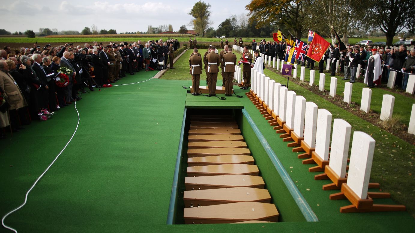 A coffin holding the remains of a soldier killed in World War I is lowered during a reburial ceremony in Bois-Grenier, France, on Wednesday, October 22. The remains of 15 British soldiers were found in 2009 during construction work near the French village of Beaucamps-Ligny. 