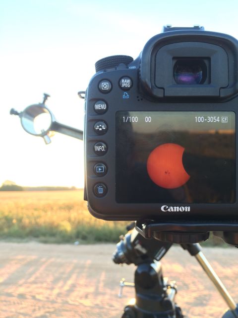 <a href="http://ireport.cnn.com/docs/DOC-1182578">Greg Hogan</a> attached his camera to a telescope and watched the partial solar eclipse from Warner Robins, Georgia, on Thursday. It "was incredible to watch the moon come in sight and over the sun slowly as the sun set," he said.