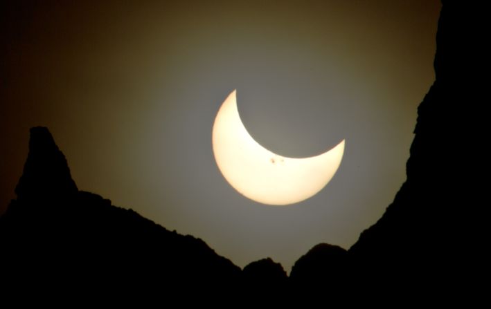 <a href="http://ireport.cnn.com/docs/DOC-1182579">John Powell</a> photographed the eclipsed sun, which looked more like a crescent moon, hanging over Badlands National Park in South Dakota.