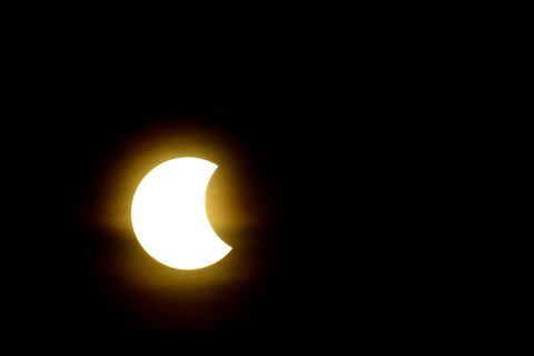 Stacking multiple polarizing filters onto his camera lens, <a href="http://ireport.cnn.com/docs/DOC-1182507">Bob Cozzi</a> captured the bright partial solar eclipse from his home in North Aurora, Illinois.
