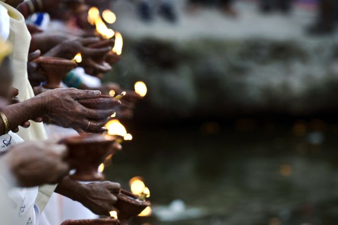 In the northern city of Vrindavan, women hold lit earthern lamps on the banks of the Yamuna River. They chant as they walk through the street during celebrations. 