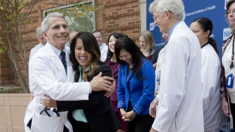 Dr. Anthony Fauci, director of the National Institute of Allergy and Infectious Diseases, hugs Nina Pham outside the National Institutes of Health in Bethesda, Maryland.