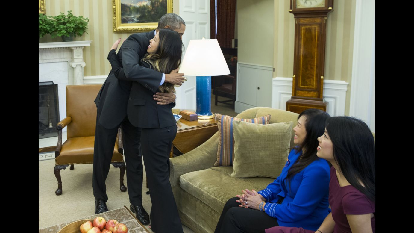U.S. President Barack Obama hugs Ebola survivor Nina Pham in the Oval Office of the White House on October 24, 2014. Pham, one of two Dallas nurses diagnosed with the virus, was declared Ebola-free after being treated at a hospital in Bethesda, Maryland. The other nurse, Amber Vinson (not pictured), was treated in Atlanta and also declared Ebola-free.