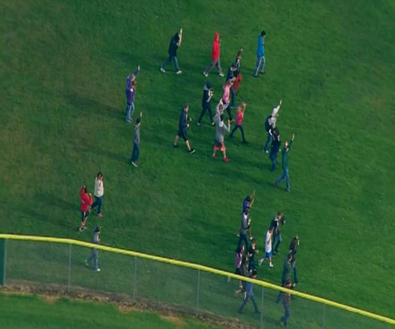 Students walk across a field after reports of shots being fired at the school.