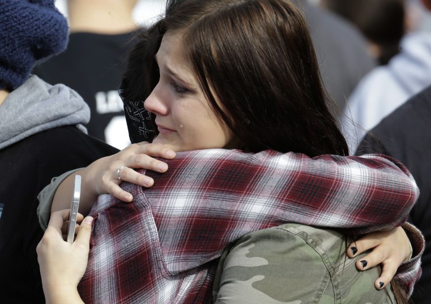 People hug after arriving at the church. 