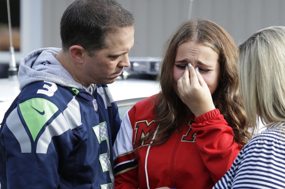 A girl is consoled at the church after the shooting.