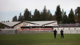 Police monitor athletic fields at Marysville-Pilchuck High School in the aftermath of the shooting.
