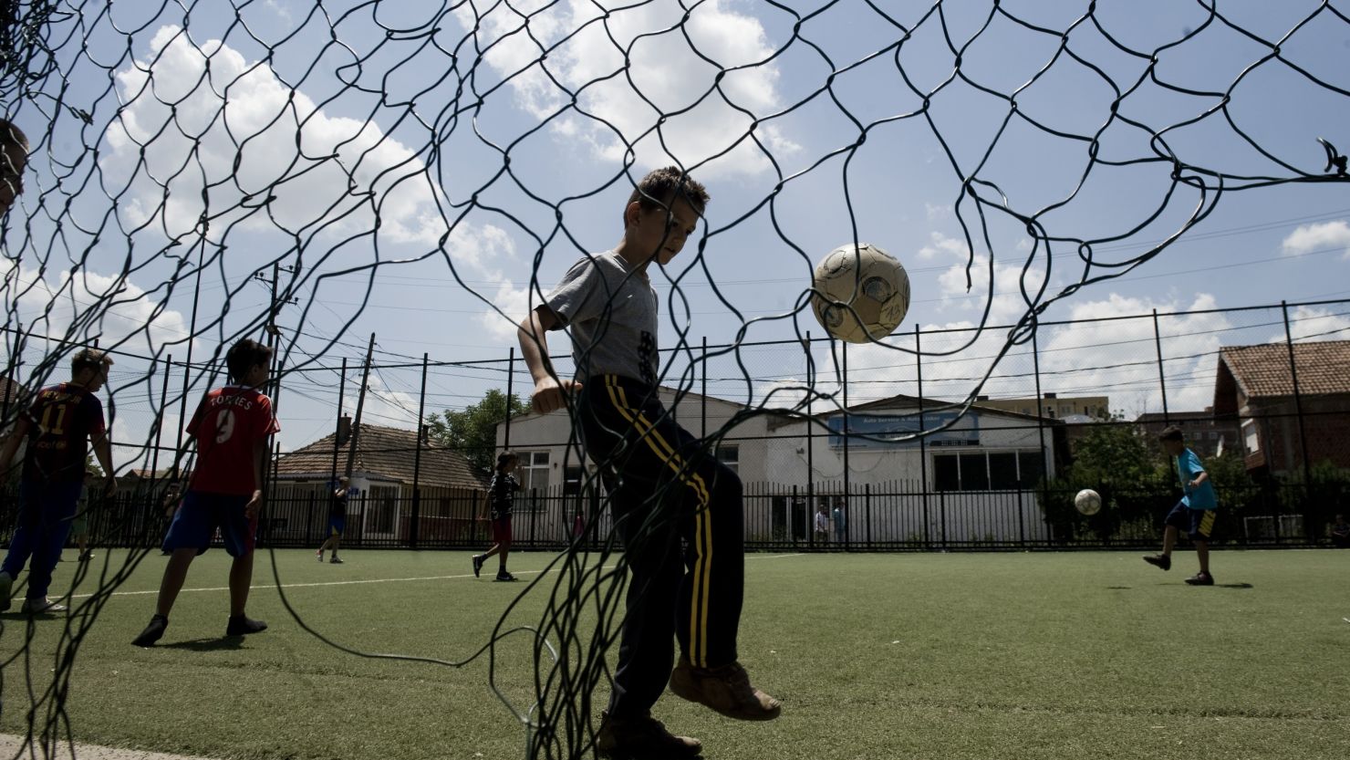 Boys enjoy playing football in Kosovo on June 29, 2014. But some parents place undue pressure on their aspiring footballers.