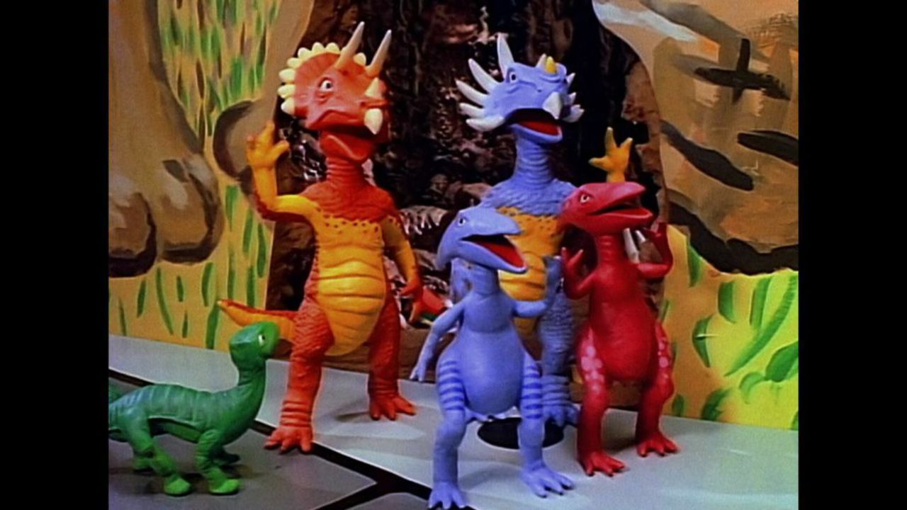The miniature Dinosaur Family -- Dinosaur <em>was</em> their last name -- lived in the Playhouse wall, like mice. 