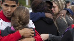 Caption:MARYSVILLE, WA - OCTOBER 24: Students and family members embrace after leaving Marysville-Pilchuck High School in the aftermath of a shooting on the high school's campus on October 24, 2014 in Marysville, Washington. At least two are dead, including the shooter, according to authorities, with several more wounded. (Photo by David Ryder/Getty Images)